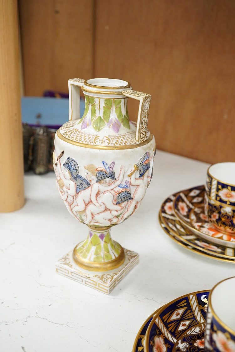 A Crown Derby Imari seven trio place setting, three other cups and two saucers, a large plate and a pair of Doccia- style vases, 18cm high